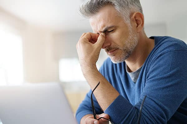 Man experiencing a migraine headache