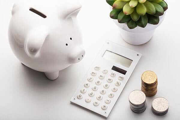 Piggy bank with calculator and change